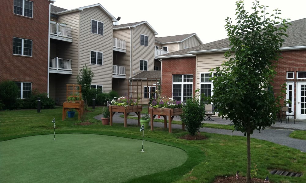 Apartments exterior and putting green at Keystone Commons in Ludlow, Massachusetts