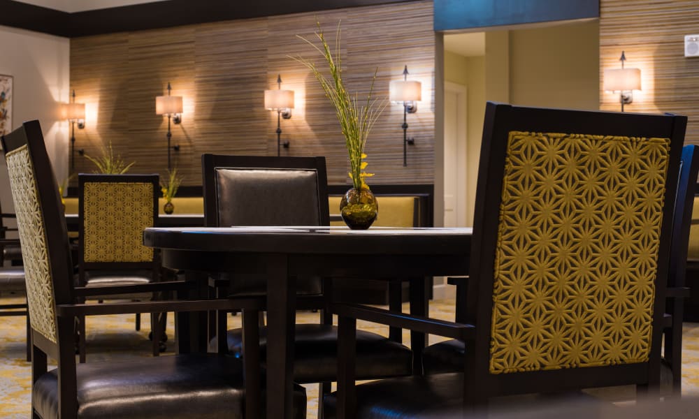 Small table in front of a wall with art at Keystone Place at Four Mile Cove in Cape Coral, Florida
