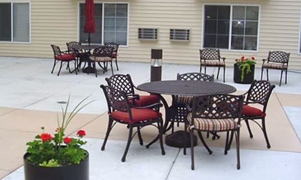 A patio with plenty of table and chairs at Parkway Gardens Senior Apartment Community in Saint Paul, Minnesota