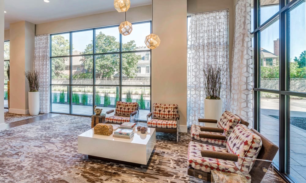 Lobby seating area with large windows showing the community at Anthology of Tanglewood in Houston, Texas