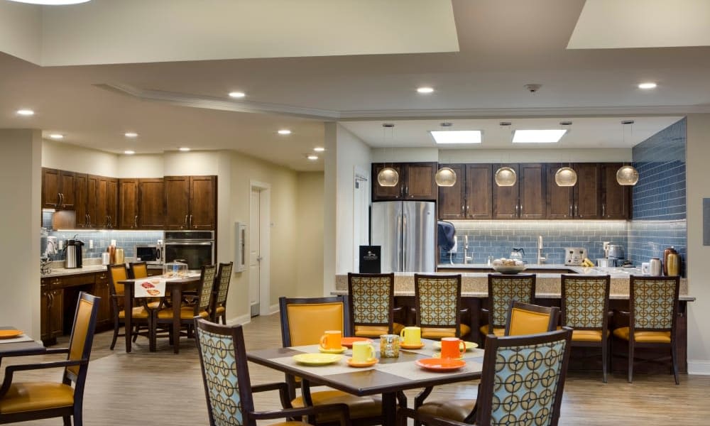 Dining room with a kitchen and bar at Anthology of Burlington Creek in Kansas City, Missouri