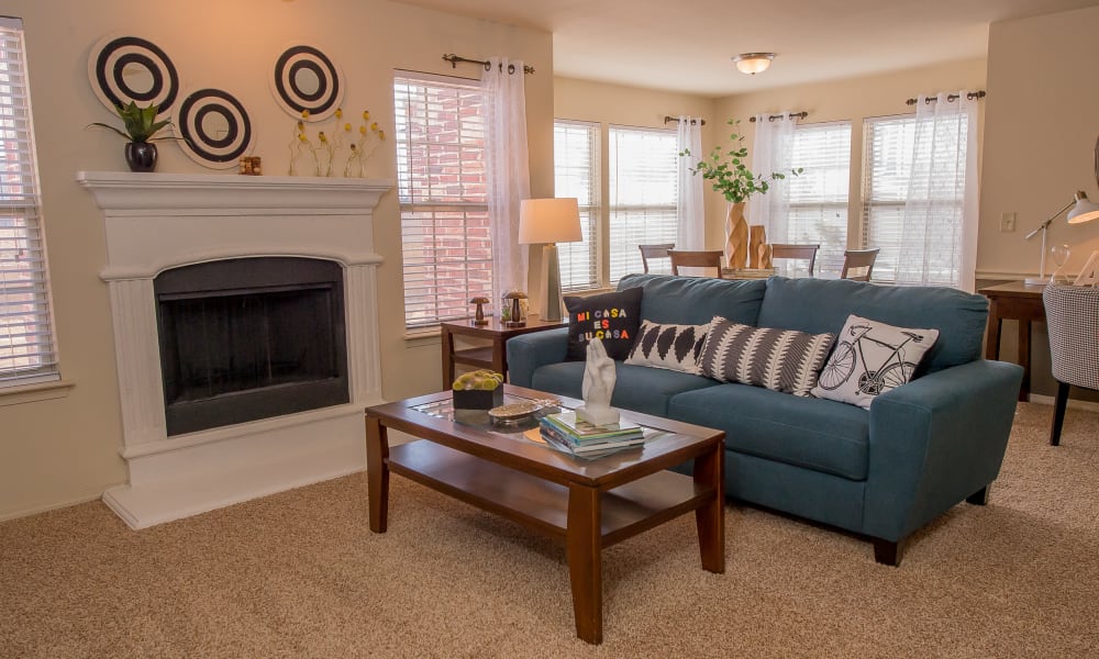 A living room with fireplace at Tuscany Hills in Tulsa, Oklahoma