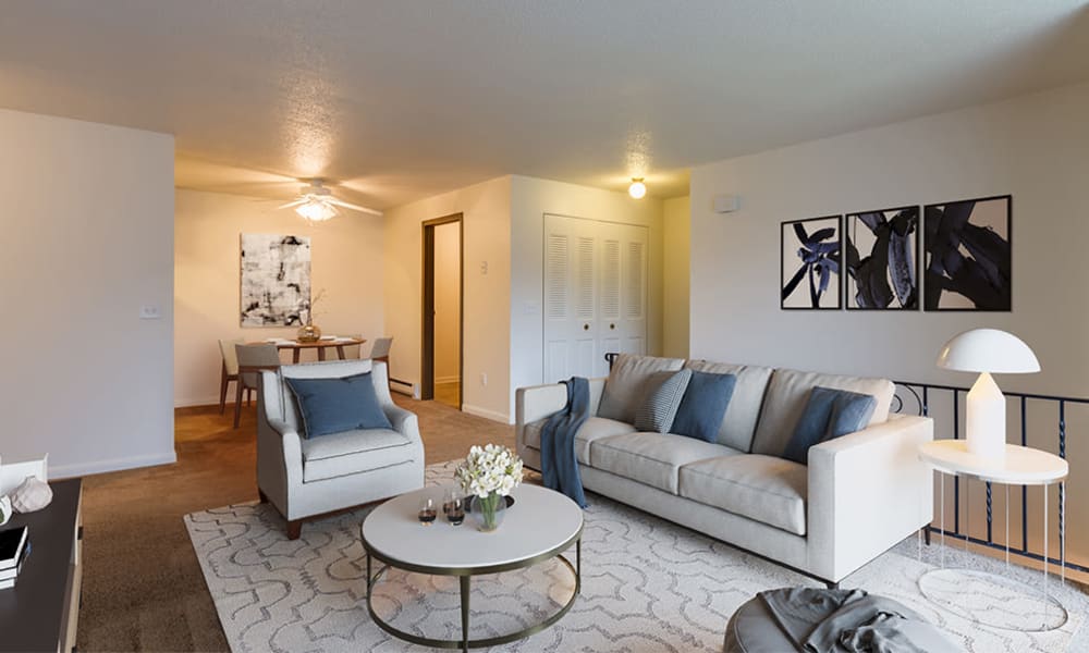 A living room that is great for entertaining at Crossroads Apartments & Townhomes in Spencerport, New York.