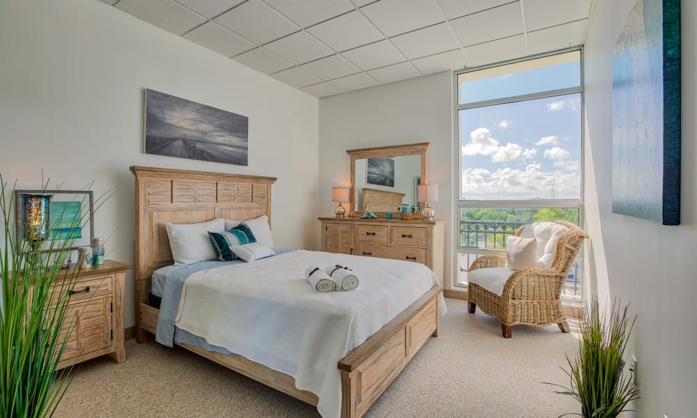 A bedroom with beautiful views at The Peninsula Assisted Living & Memory Care in Hollywood, Florida
