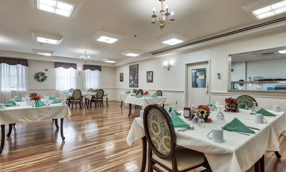 A dining hall with hardwood-style floors at Hillhaven in Adelphi, Maryland