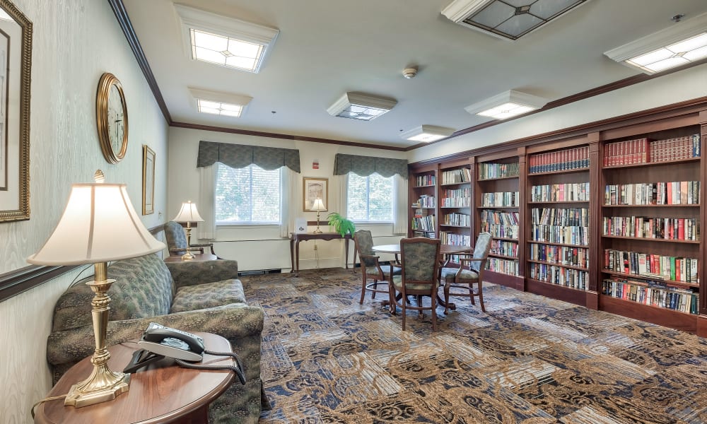 Fully stocked bookcases in a reading room at Hillhaven in Adelphi, Maryland