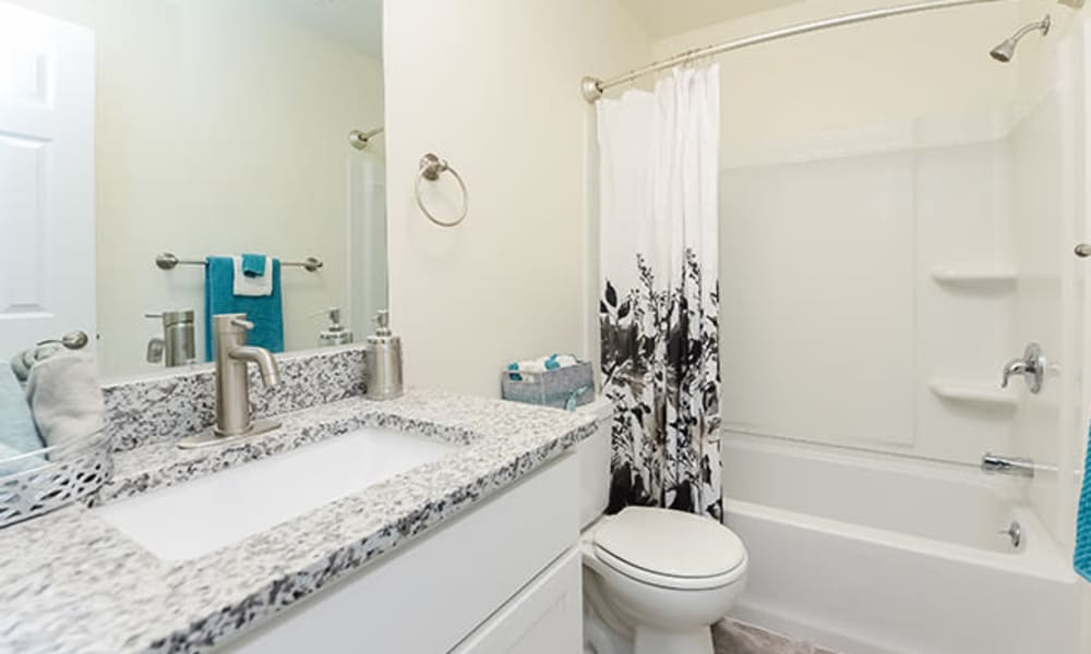 Bathroom with granite countertop at Whitestone Village Apartment Homes in Allentown, Pennsylvania