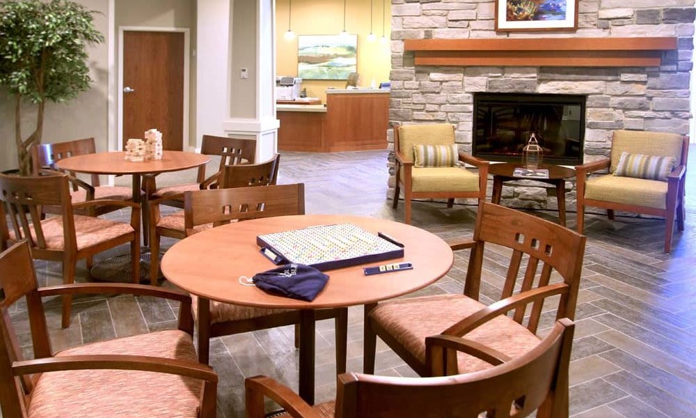 Community room with a fireplace at Anthology of Wheaton in Wheaton, Illinois. 