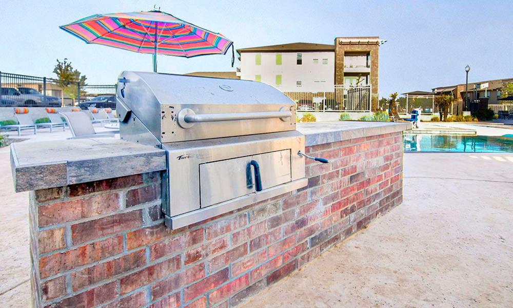 Barbecue area near the swimming pool at Anatole on Briarwood in Midland, Texas