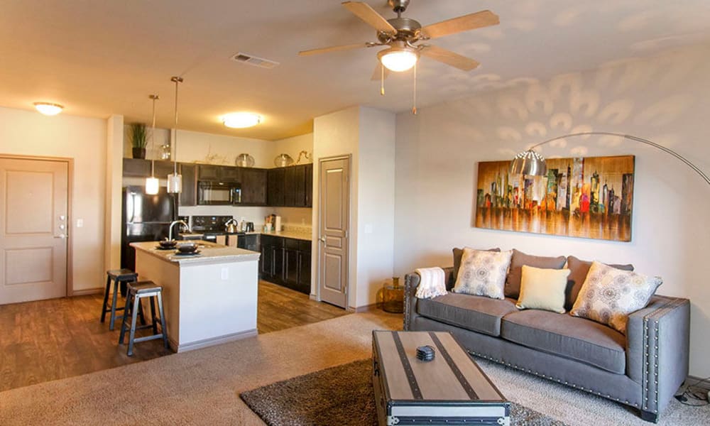 Ceiling fan and plush carpeting in the living area of a model home at Anatole on Briarwood in Midland, Texas