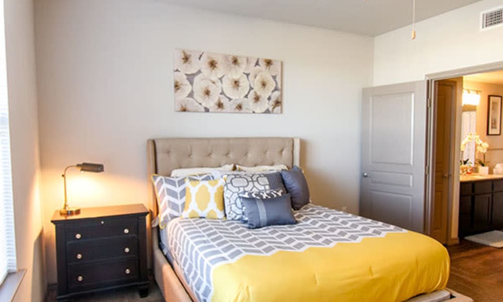Well-decorated primary bedroom in a model home at Anatole on Briarwood in Midland, Texas