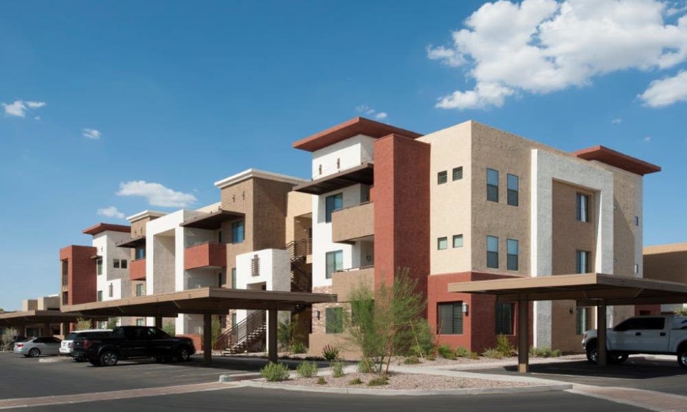 Exterior view of resident buildings and covered parking at Vive in Chandler, Arizona