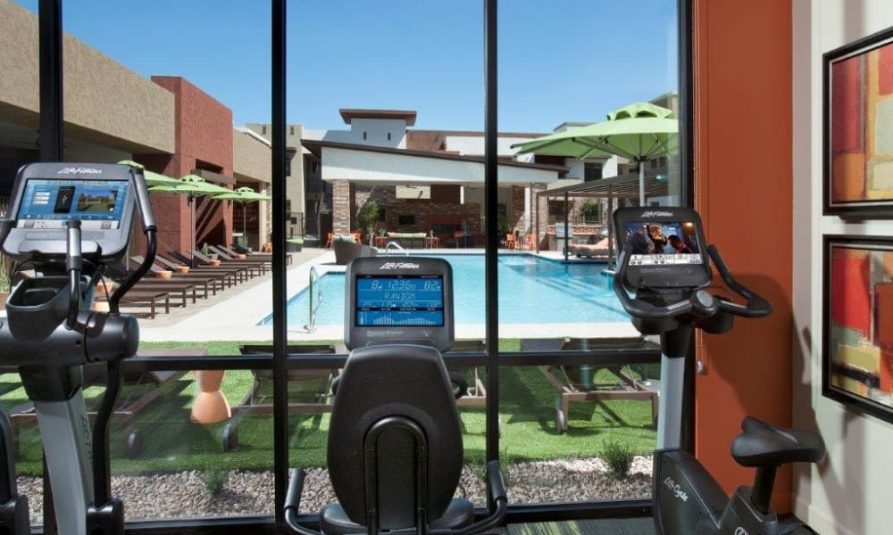 Great view of the swimming pool from the cardio equipment in the fitness center at Vive in Chandler, Arizona