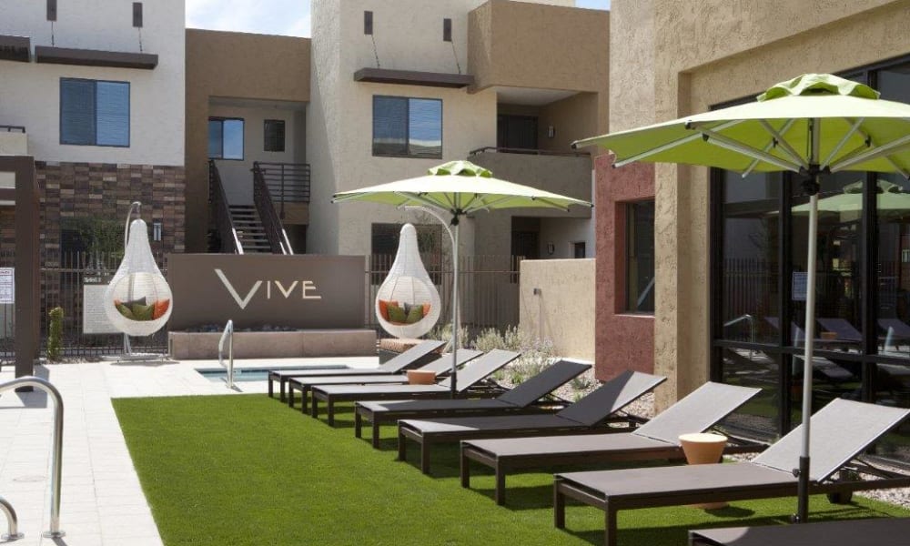 Chaise lounge chairs near the pool at Vive in Chandler, Arizona