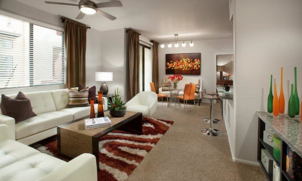 Ceiling fan and plush carpeting in the living area of a model home at Vive in Chandler, Arizona