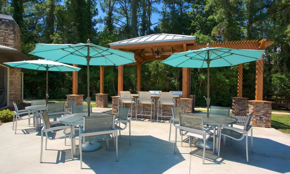 Shaded seating near the barbecue area at Wimberly at Deerwood in Jacksonville, Florida