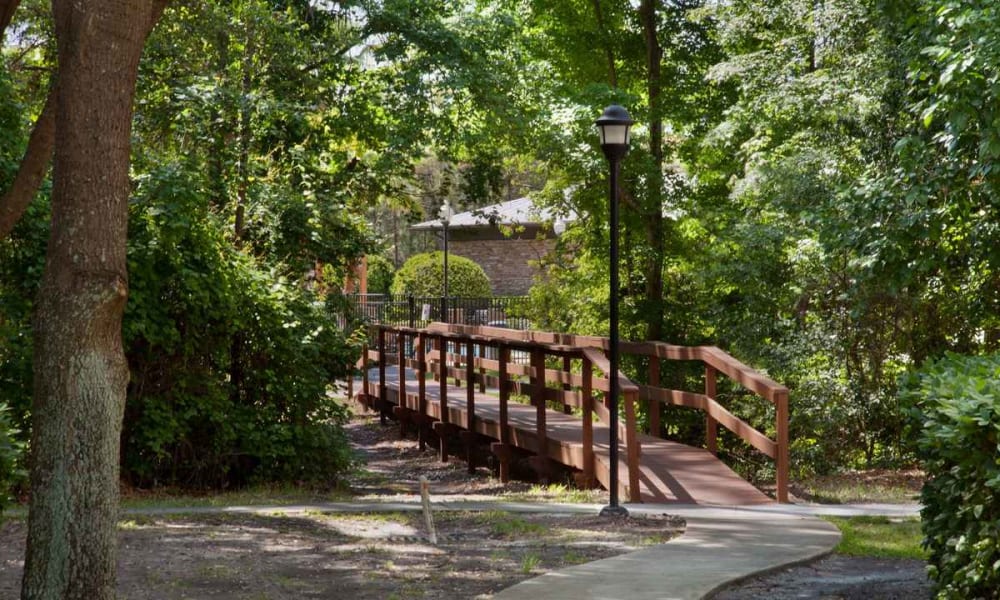 Wooden bridge across a creek at Wimberly at Deerwood in Jacksonville, Florida