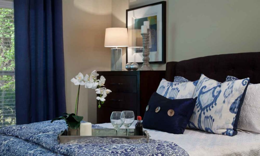 Comfortably furnished primary bedroom in a model home at Wimberly at Deerwood in Jacksonville, Florida