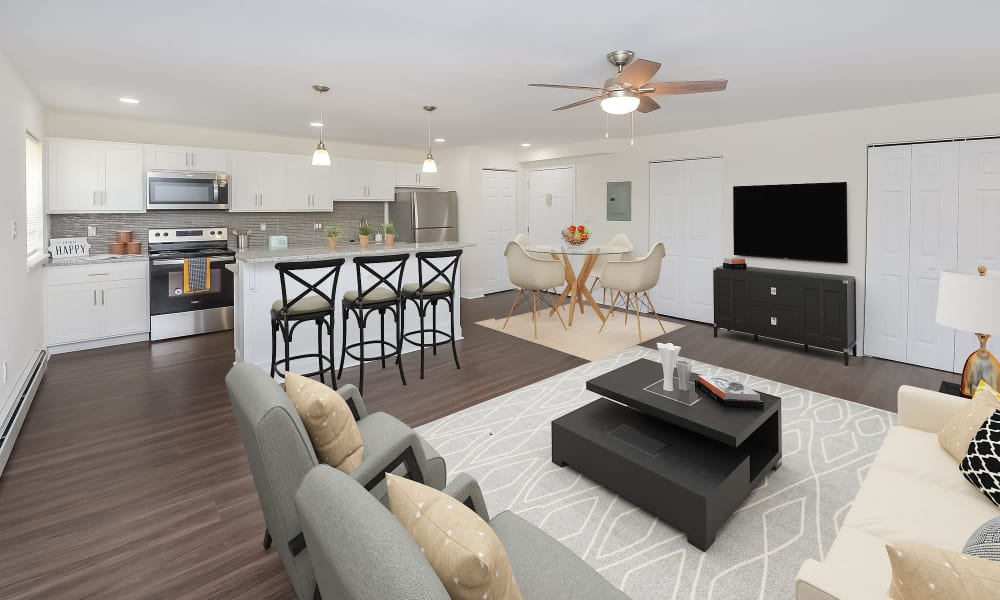 Open concept living room and kitchen of a beautiful model home at Kingswood Apartments & Townhomes in King of Prussia, Pennsylvania