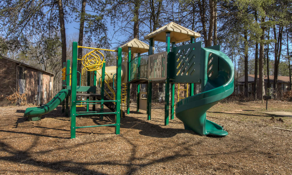 A children's playground with a slide at Enclave at North Point Apartment Homes in Winston Salem, North Carolina