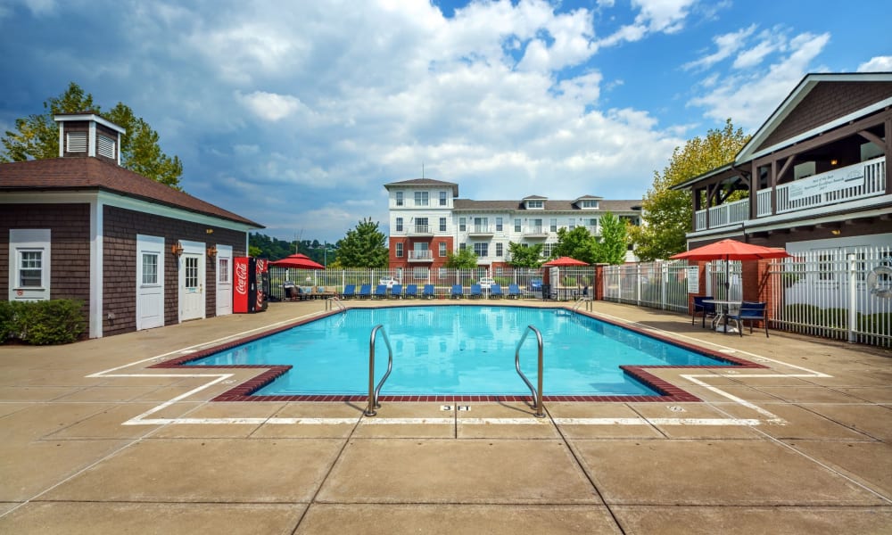 Swimming pool and outdoor seating around at The Waterfront Apartments & Townhomes in Munhall, Pennsylvania