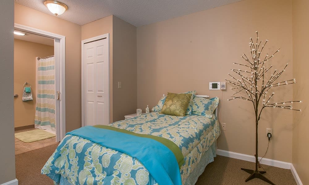 Memory care bedroom suite at Randall Residence of Newark in Newark, Ohio