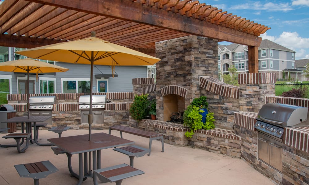 Grilling area next to pool with tables to use at Artisan Crossing in Norman, Oklahoma