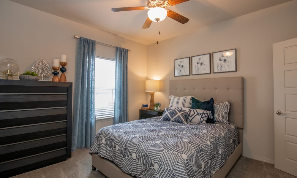 Bedroom with ceiling fan and carpet at Artisan Crossing in Norman, Oklahoma