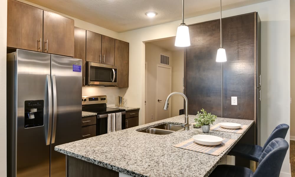 Spacious kitchen featuring breakfast bar seating at Fusion apartments in Jacksonville, Florida