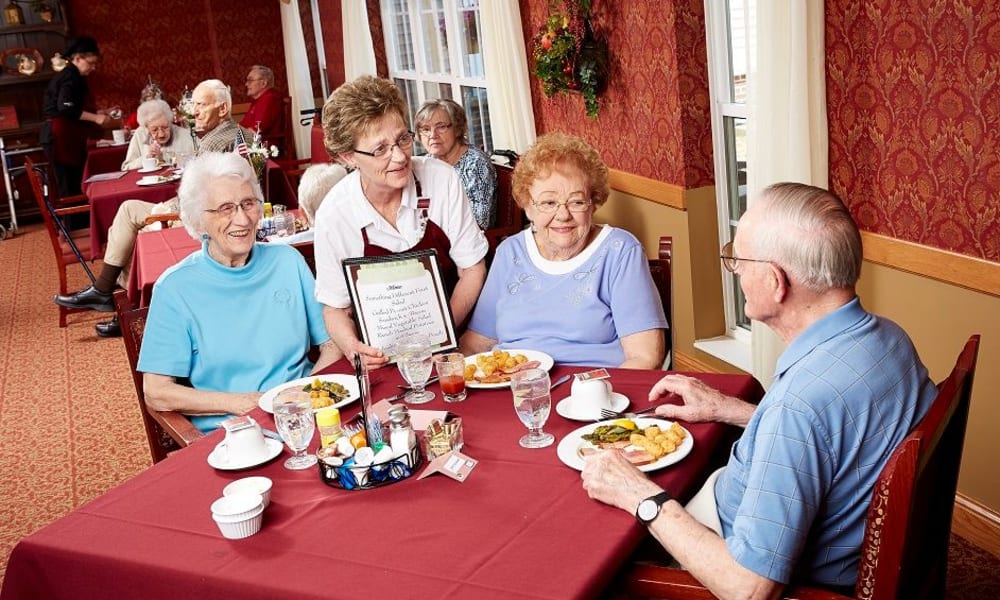 Residents looking at a menu in the dining hall at Deer Crest Senior Living in Red Wing, Minnesota