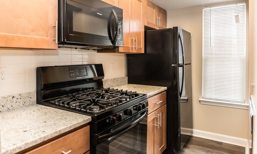 A kitchen with black appliances at Greenhills Apartments & Townhomes in Damascus, Maryland