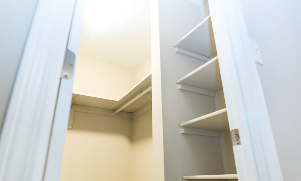 A walk in closet with plenty of shelving at Greenhills Apartments & Townhomes in Damascus, Maryland
