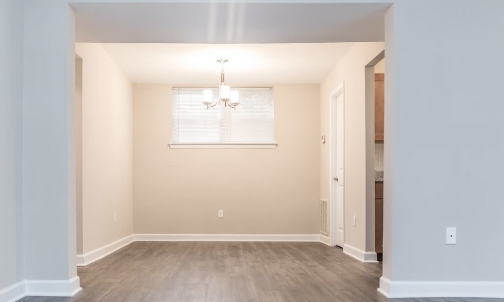 Dining room with wood-style flooring at Greenhills Apartments & Townhomes in Damascus, Maryland