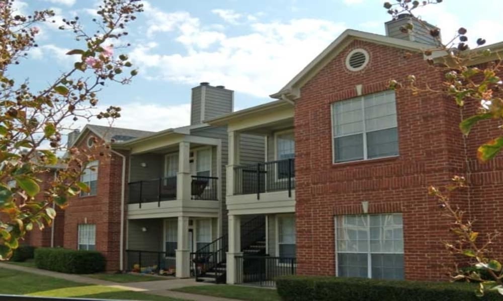 Exterior of homes with private balconies at Champion Lake Apartment Homes in Shreveport, Louisiana