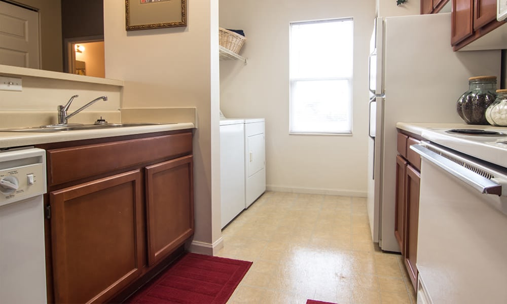 Kitchen and laundry area in a home at Avalon at Northbrook Apartments & Townhomes in Fort Wayne, Indiana