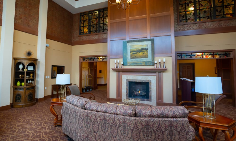 Fireplace lounge with a semi-circular couch opposing the fire pit at York Gardens in Edina, Minnesota