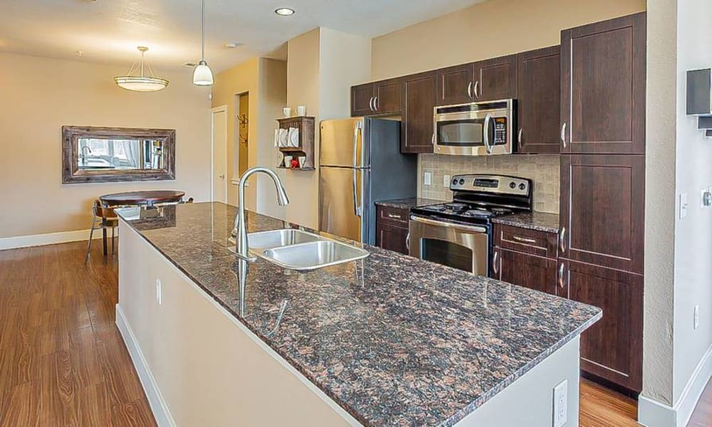 Kitchen with granite counters at The Landings at Brooks City-Base in San Antonio, Texas