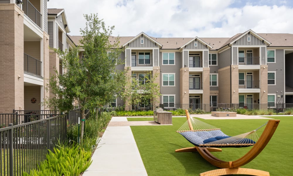 Courtyard lounge with hammocks at Bellrock Market Station in Katy, Texas