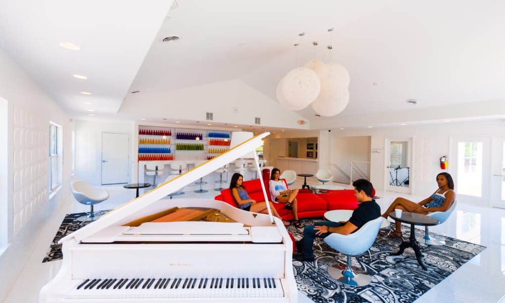 Modern resident clubhouse with a grand piano at Woodland Mews in Ann Arbor, Michigan