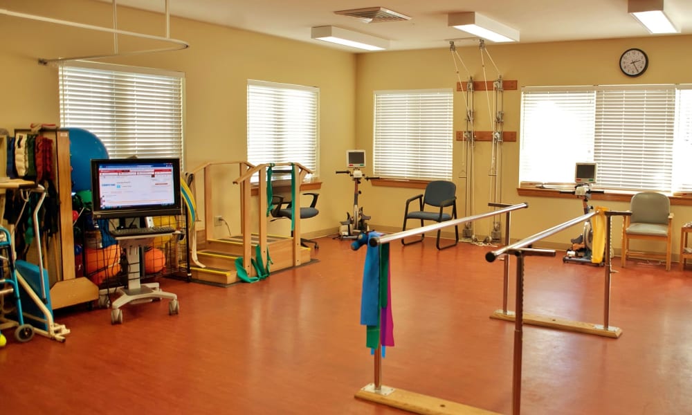 Rehabilitation therapy gym with a large variety of equipment to get residents back on their feet at Fair Oaks Health Care Center in Crystal Lake, Illinois