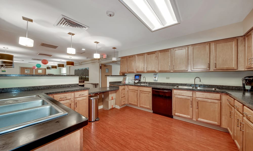 Community kitchen with lots of counter space and hardwood floors at Fair Oaks Health Care Center in Crystal Lake, Illinois