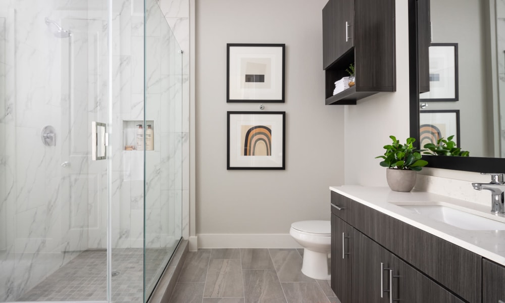 Modern bathroom with glass shower at Bellrock Sawyer Yards in Houston, Texas