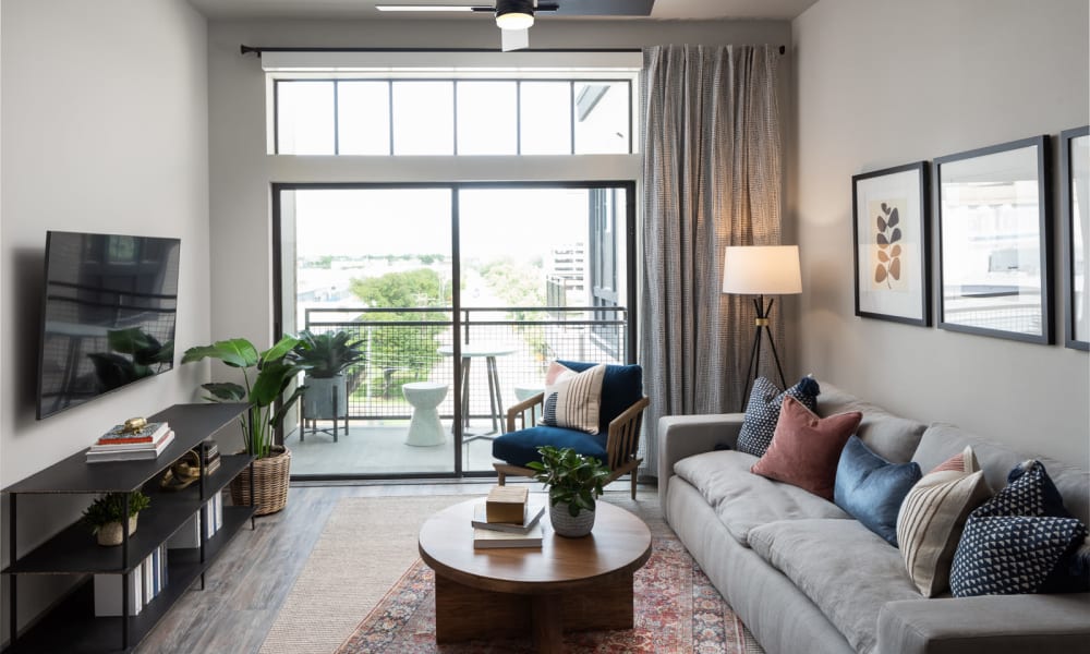 Living room area with ample natural light at Bellrock Sawyer Yards in Houston, Texas