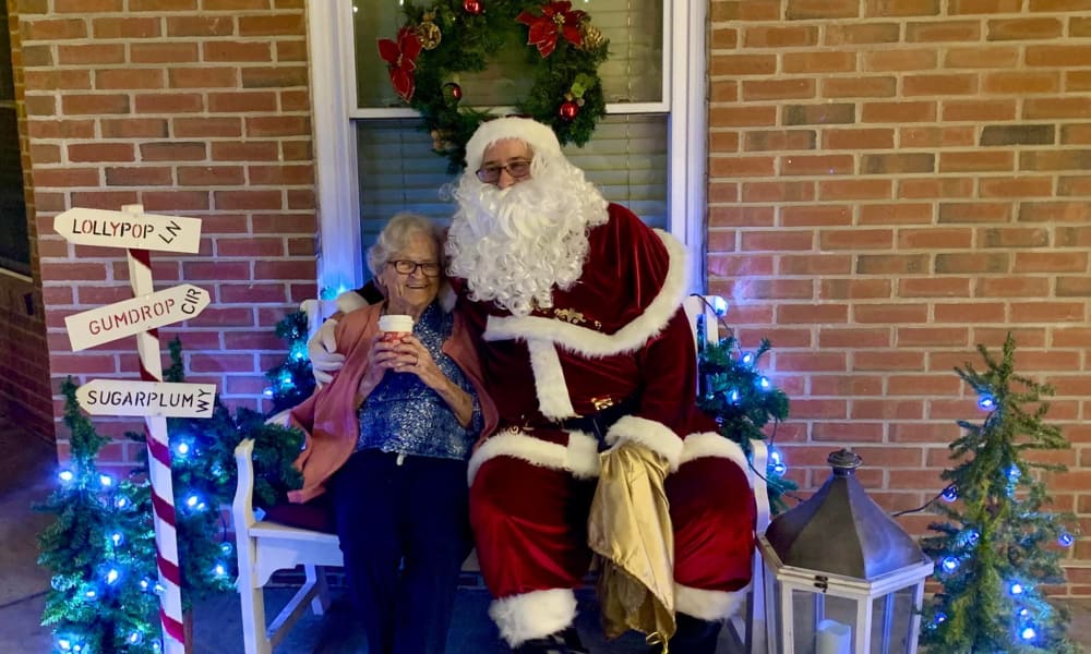 Resident taking a photo with Santa at The Birches at Harleysville in Harleysville, Pennsylvania