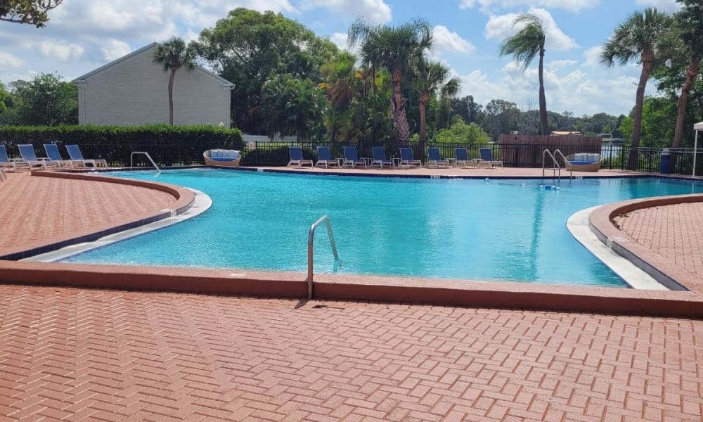 Luxurious outdoor swimming pool area at Park at Lake Magdalene Apartments & Townhomes in Tampa, Florida