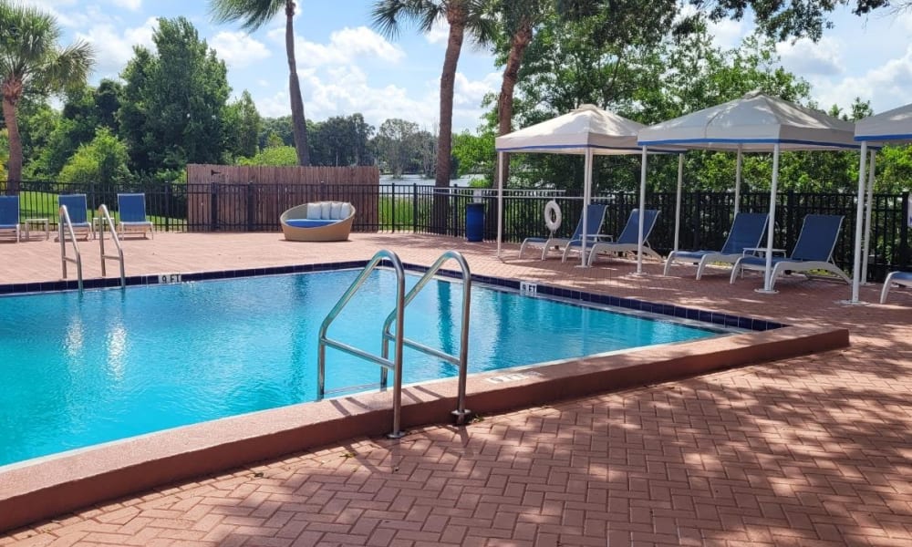 Outdoor swimming pool area at Park at Lake Magdalene Apartments & Townhomes in Tampa, Florida