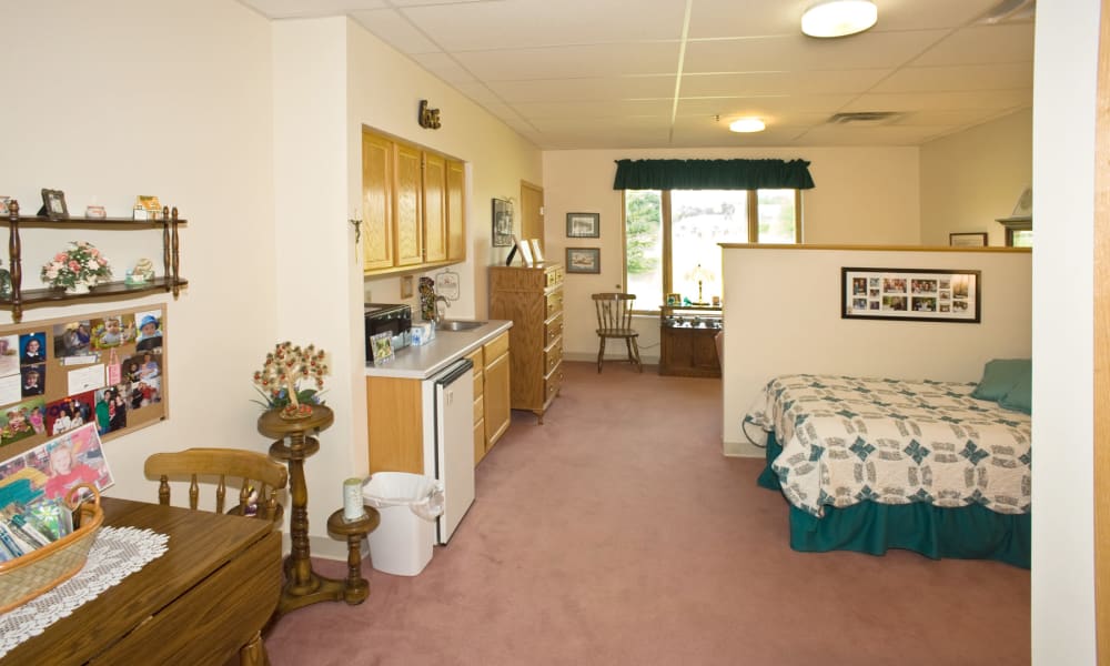 Resident bedroom with kitchen area at Wellington Place at Hartford in Hartford, Wisconsin