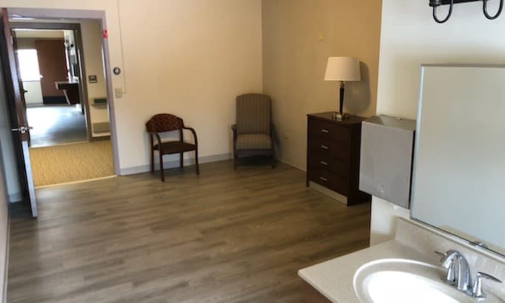 Seating and bathroom amenities in a room at Villas At Maple Ridge in Spooner, Wisconsin