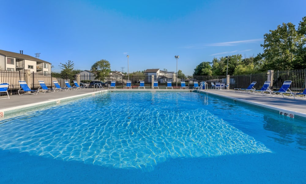 Sparkling swimming pool surrounded by lounge chairs at Lakeside Crossing at Eagle Creek in Indianapolis, Indiana