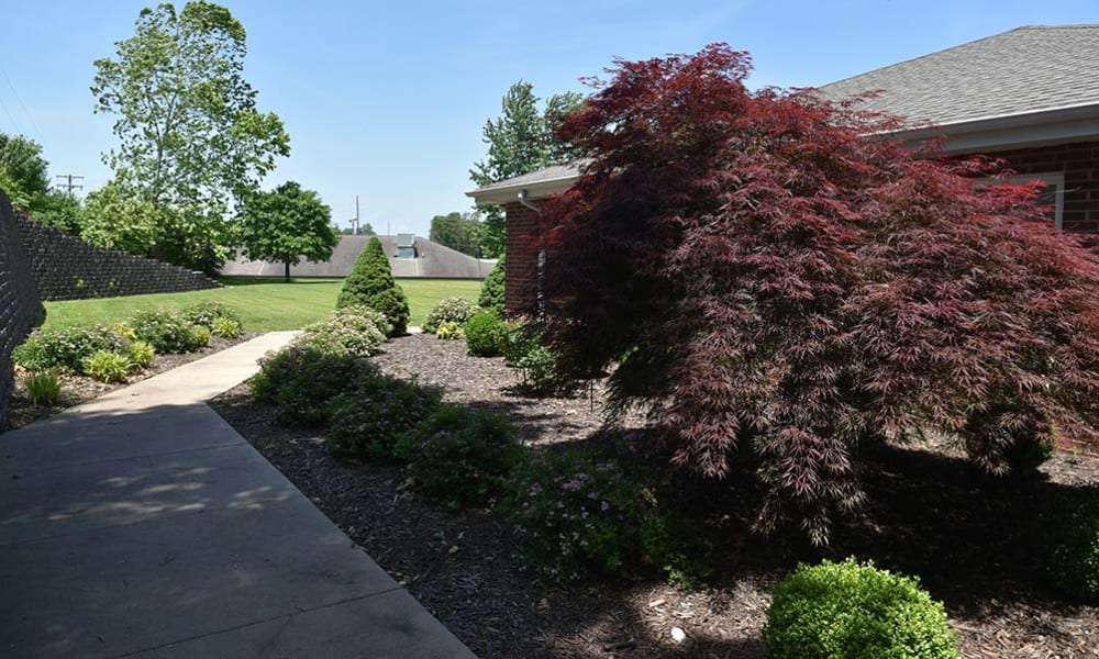 Flat walking paths in beautiful landscaping at Henley Place in Neosho, Missouri